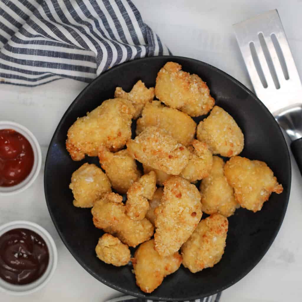 air fryer frozen chicken nuggets next to BBQ sauce