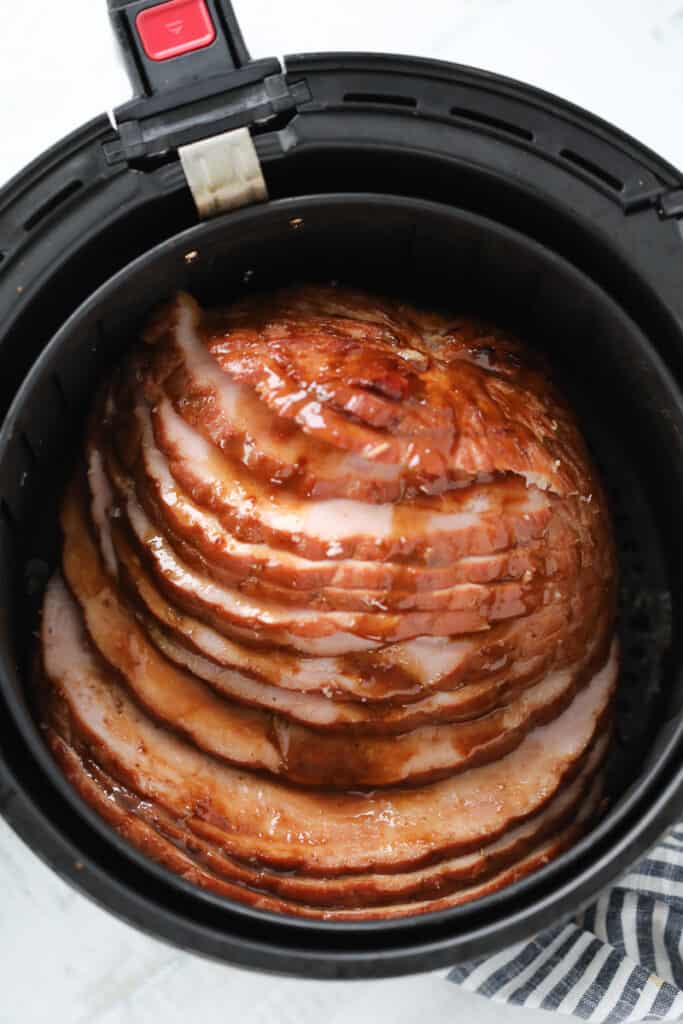 sliced air fryer ham drizzled with glaze