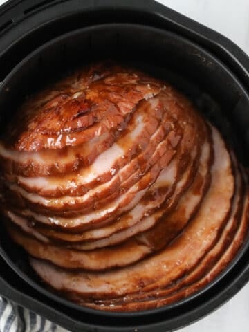 the ham in air fryer recipe sliced and covered with glaze