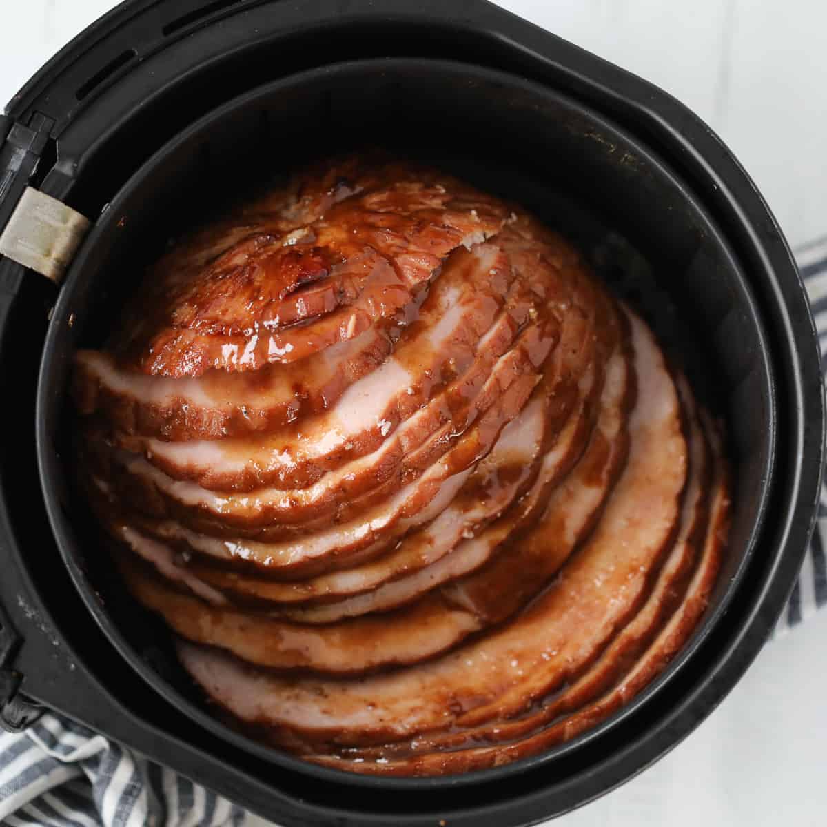 the ham in air fryer recipe sliced and covered with glaze