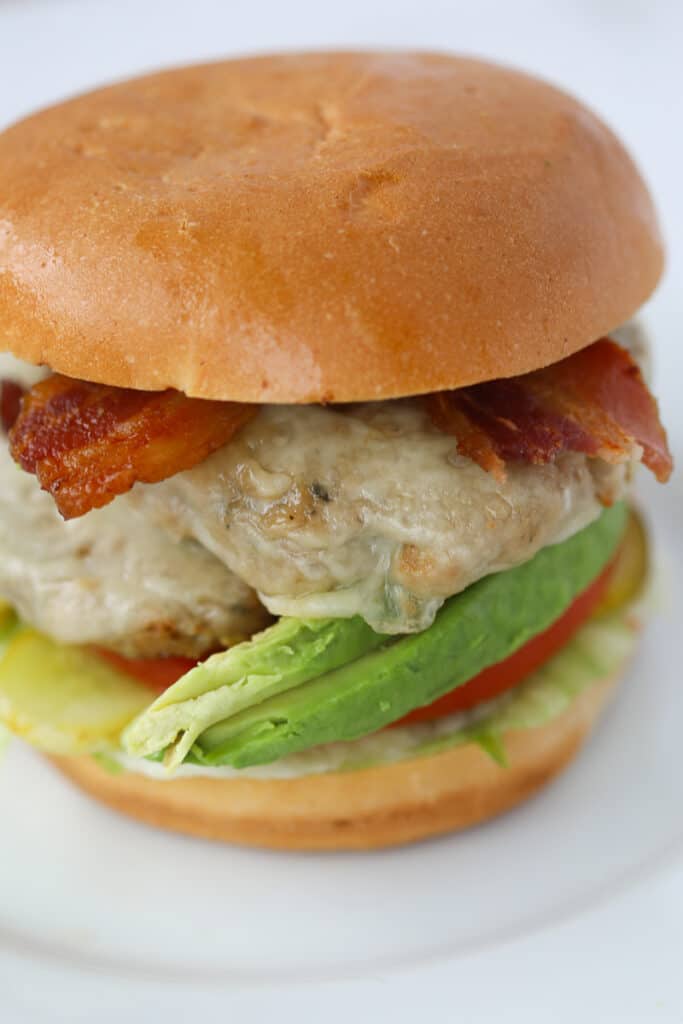 the turkey burgers in air fryer recipe on a bun with bacon and toppings