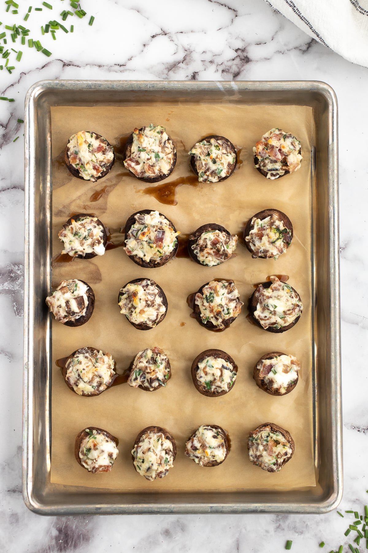 easy baked stuffed mushrooms with cream cheese and bacon bits cooling on the pan after baking