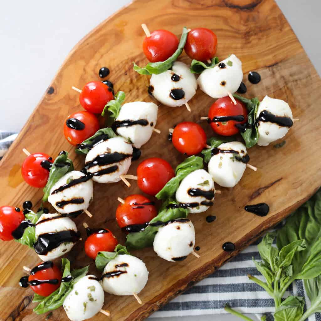 caprese salad skewers on a cutting board