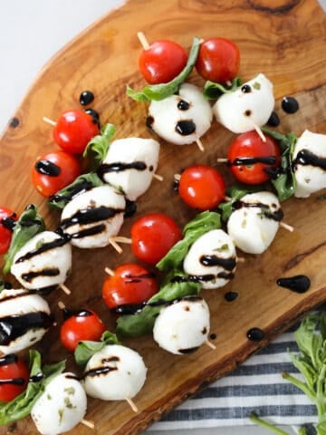 caprese salad skewers on a cutting board