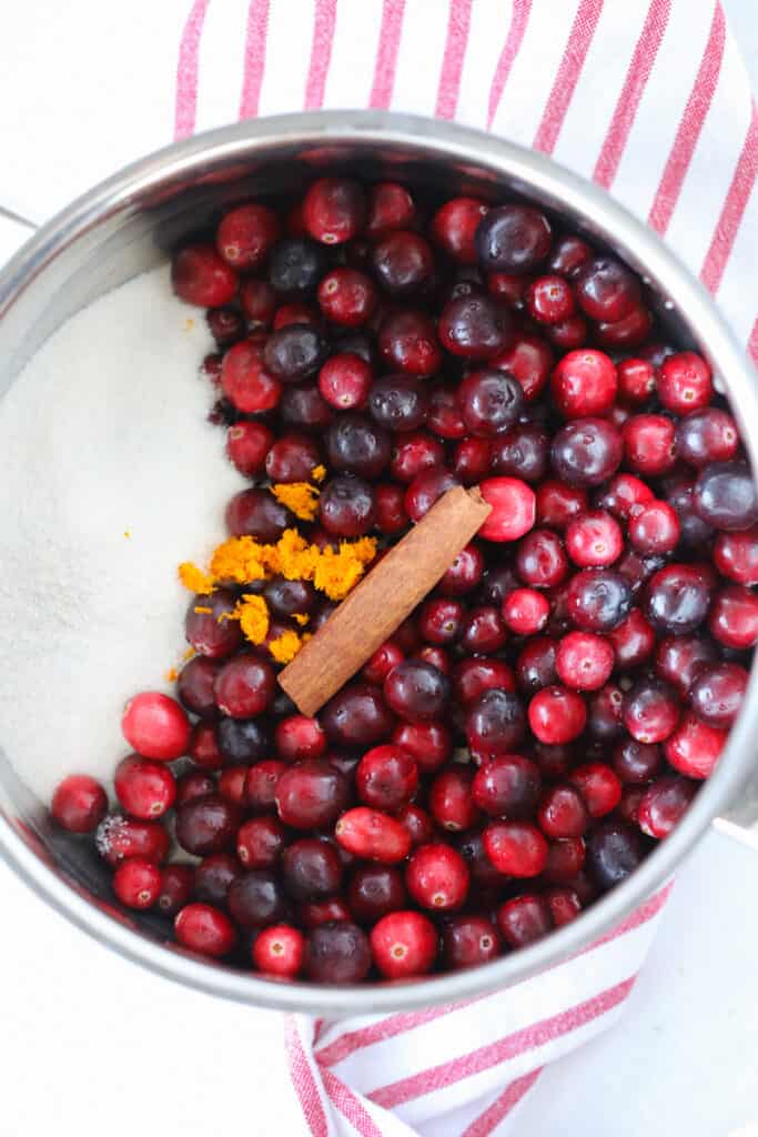 cranberry sauce keto ingredients added to a pot before cooking