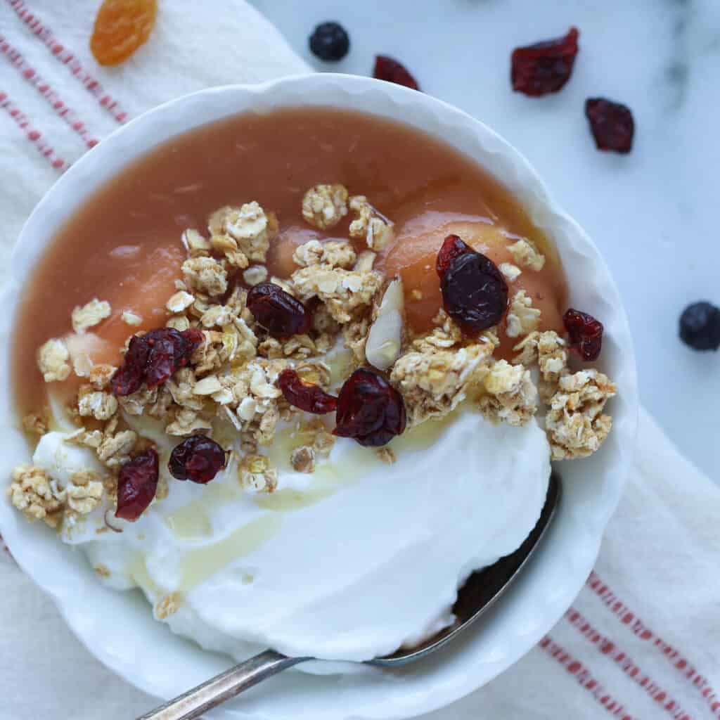 instant pot apple sauce in a bowl with yogurt and granola