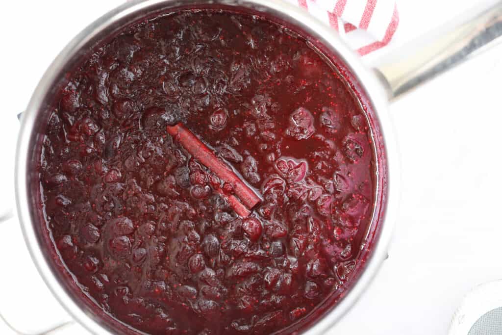 the homemade keto friendly cranberry sauce cooling on the stovetop after cooking