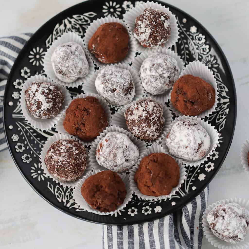 low carb rum balls covered in coconut, powdered erythrtitol, and cocoa powder