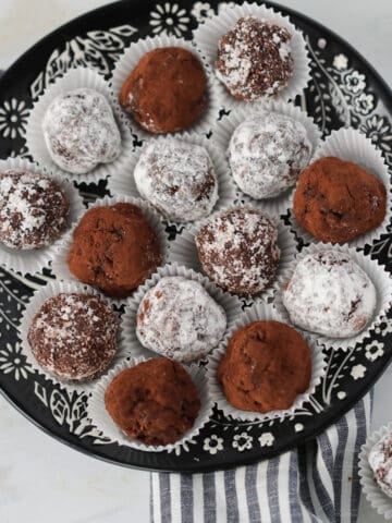 low carb rum balls covered in coconut, powdered erythrtitol, and cocoa powder