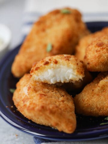 the frozen fish in air fryer recipe with a bite out of a piece after cooking