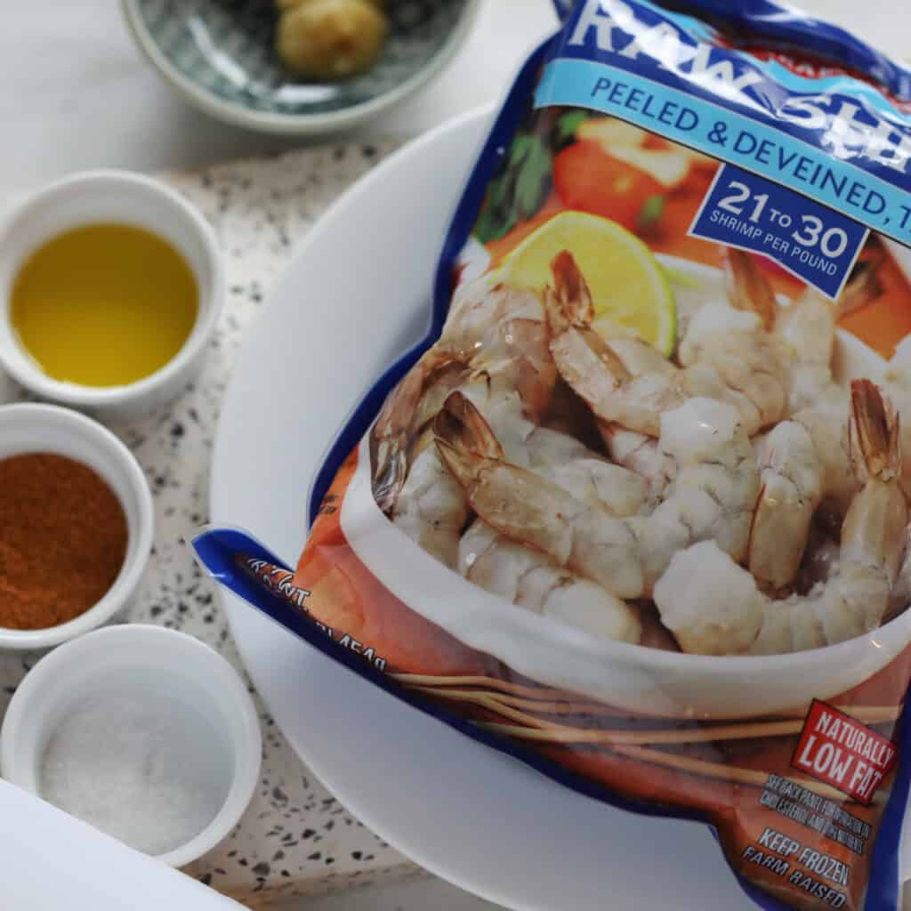 the air fryer cajun shrimp ingredients on a white board