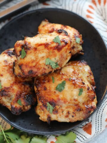 air fryer frozen chicken thighs with a honey mustard glaze with garnishes