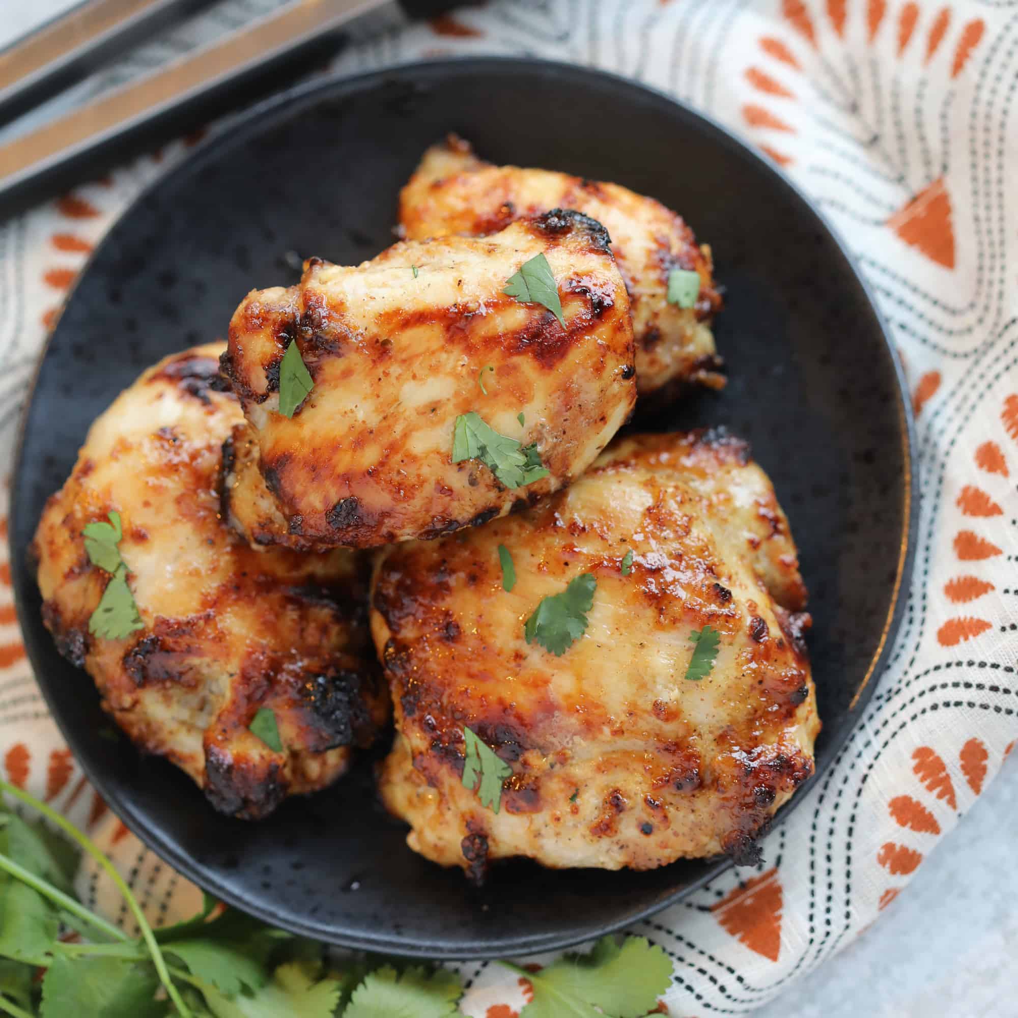 air fryer frozen chicken thighs with a honey mustard glaze with garnishes