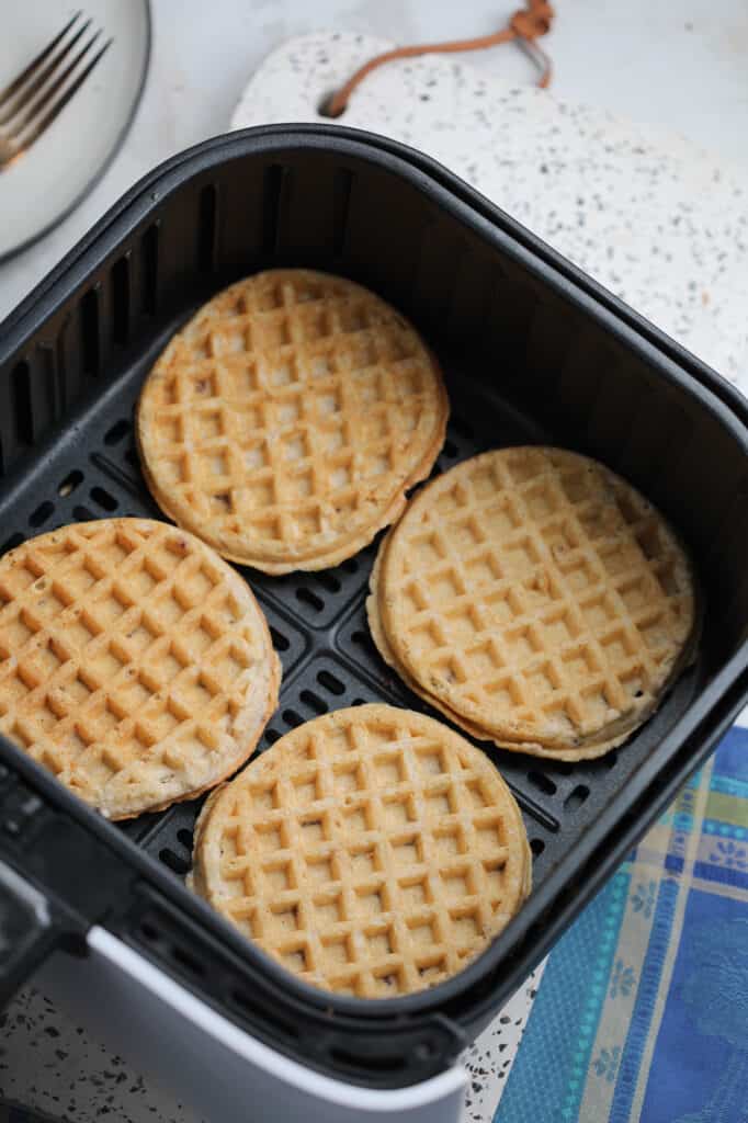 cooking air fryer waffles starts by laying them out in a single layer