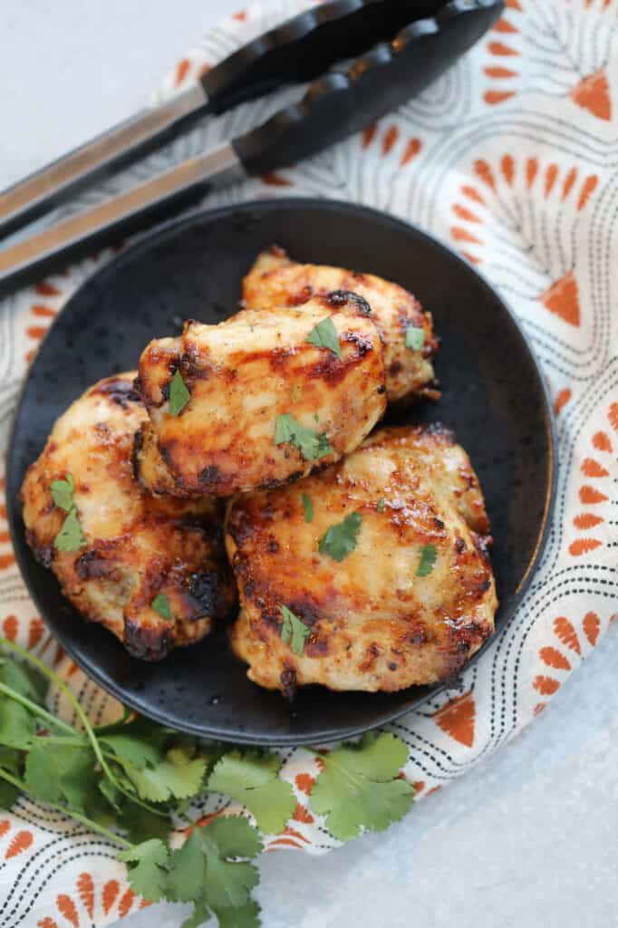frozen chicken thighs air fryer after cooking staged with herbs