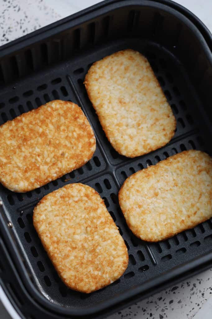lay the frozen hash browns air fryer patties spread out in the basket