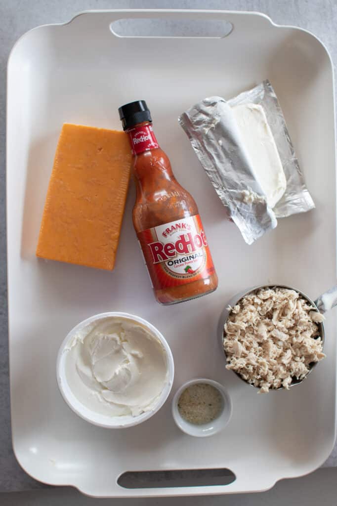 keto buffalo chicken dip ingredients on a white tray