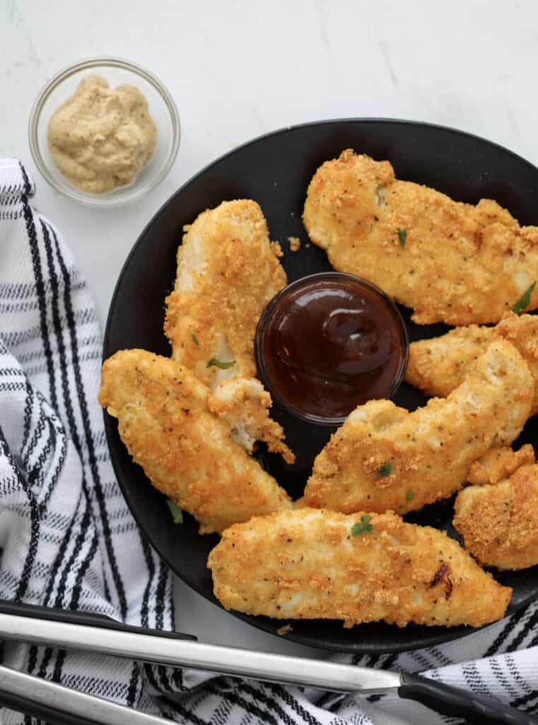 air fryer chicken tenders keto recipe with sauce to dip after cooking on a plate