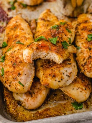 baked tenders no breading on a pan stacked up