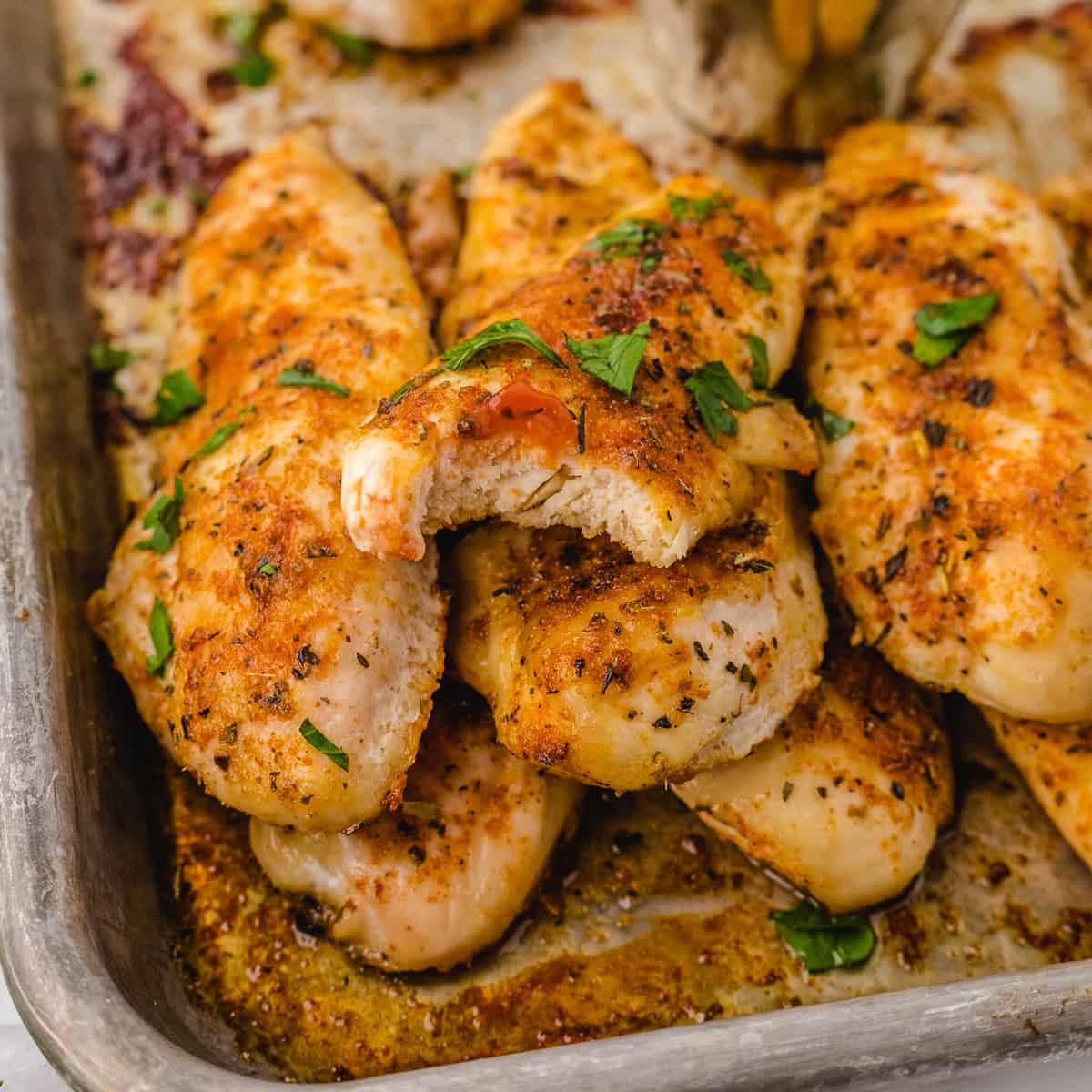 baked tenders no breading on a pan stacked up