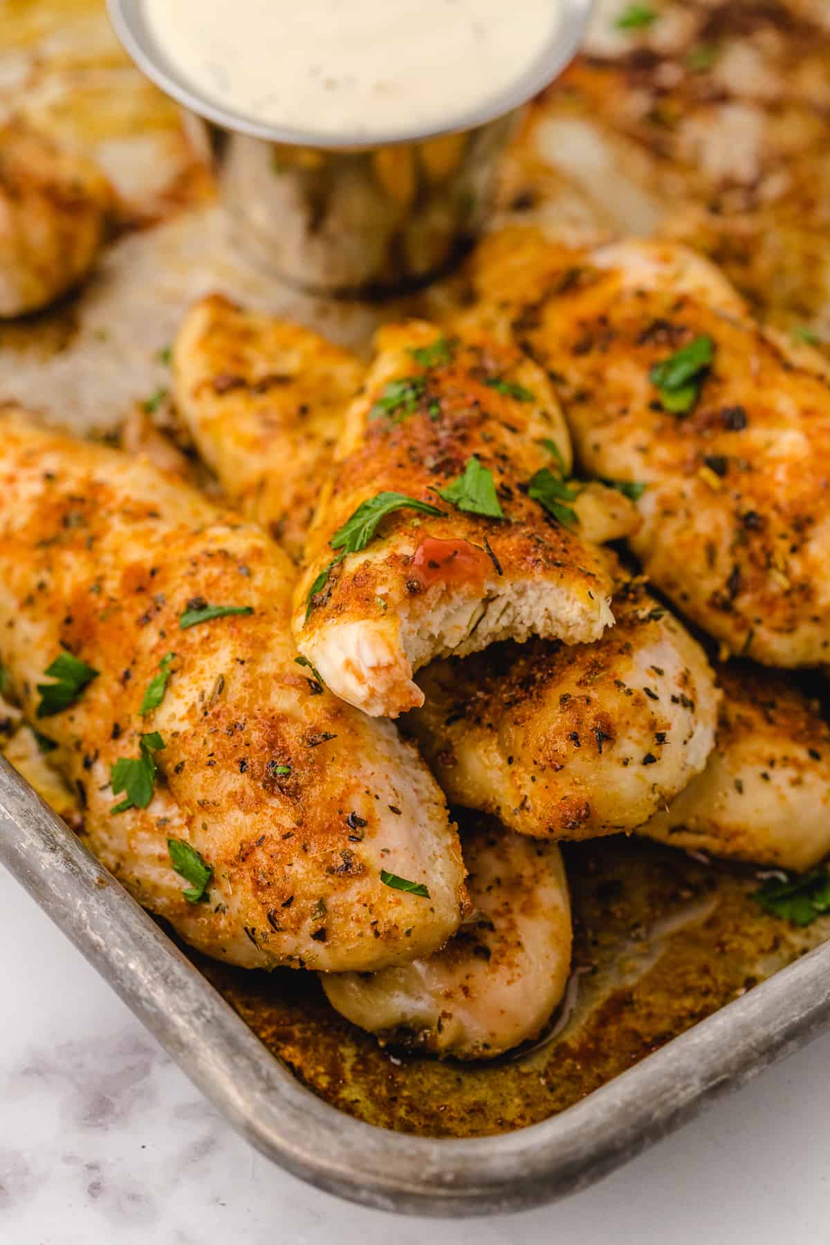baked chicken tenders recipe after cooking on a prepared baking sheet