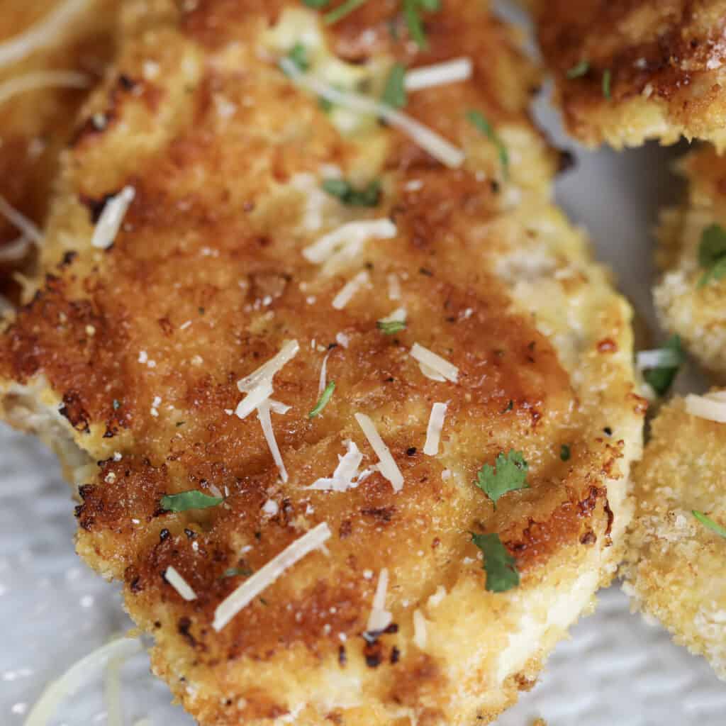 breaded and baked chicken cutlets in oven close up photo after cooking
