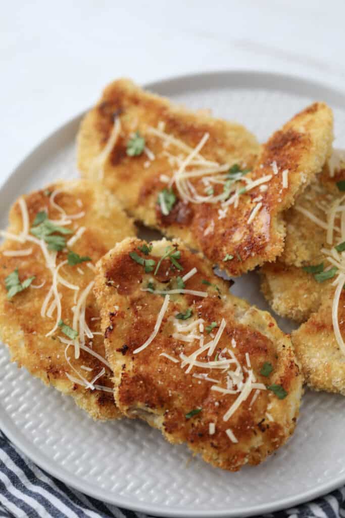 breaded baked chicken cutlets on a white plate