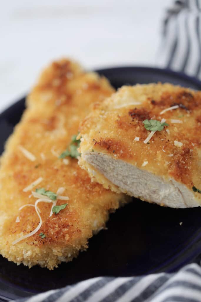 chicken cutlets in oven after baking with a bite sliced off