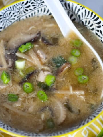 pressure cooker hot and sour soup in a bowl with an Asian spoon