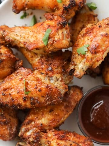 a bbq dry rub for air fryer wings gets sprinkled on the wings and then cooked. serve with bbq sauce