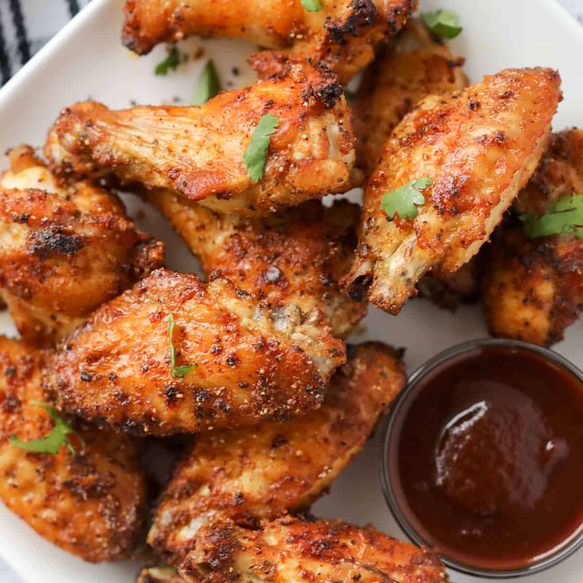 a bbq dry rub for air fryer wings gets sprinkled on the wings and then cooked. serve with bbq sauce
