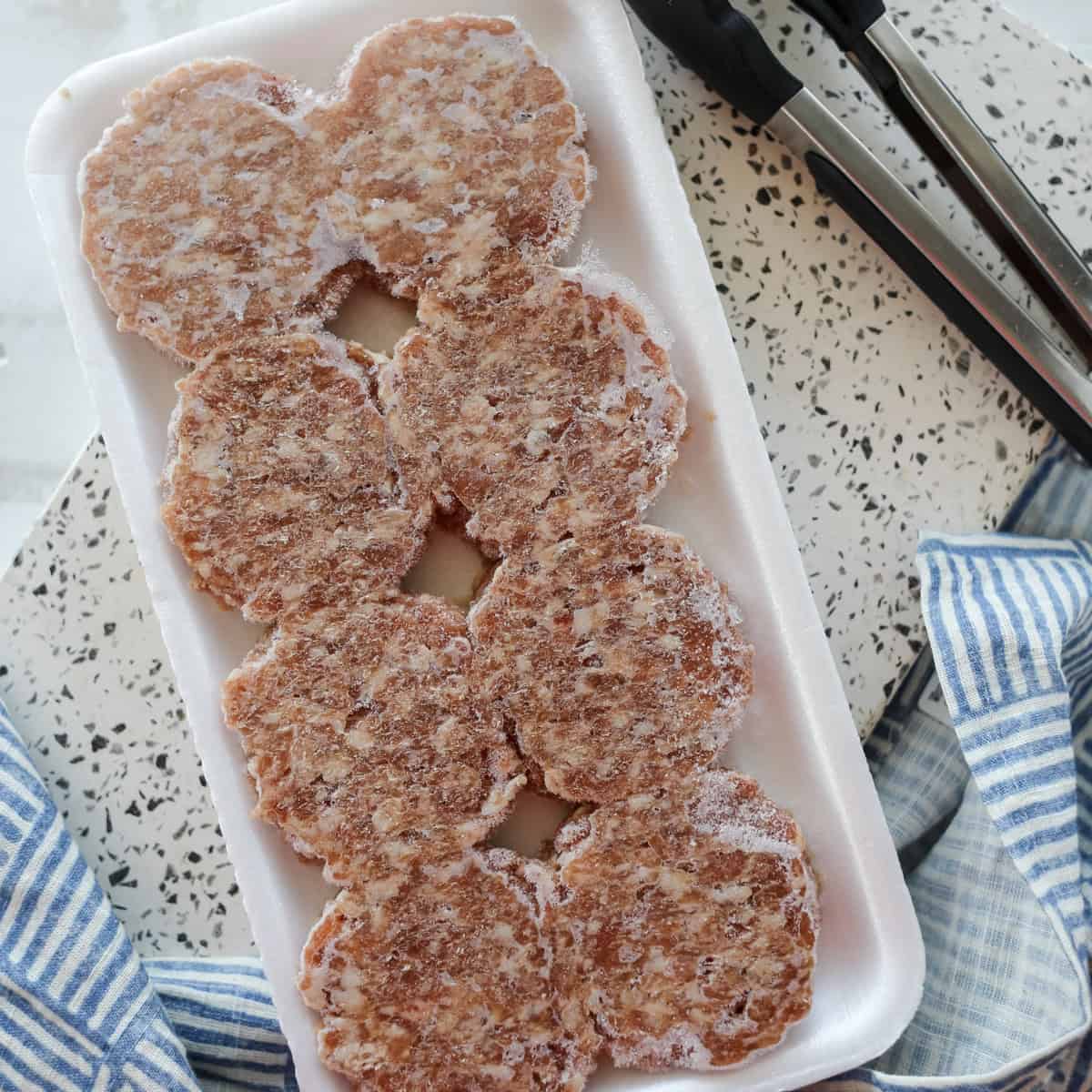 frozen patties on a tray before cooking