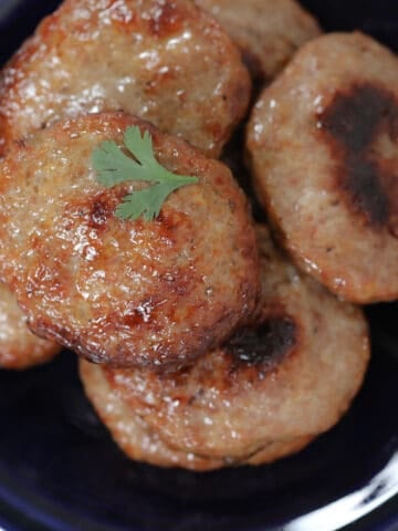 sausage patties in oven up close on a plate after cooking