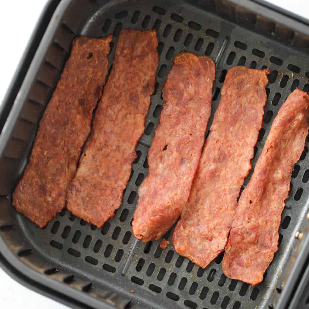 the turkey bacon in air fryer recipe sitting in the basket after cooking