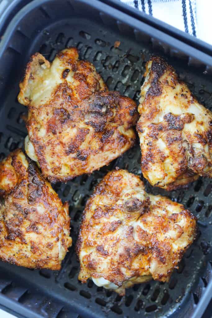 air fryer bone in chicken thighs in the air fryer basket after cooking