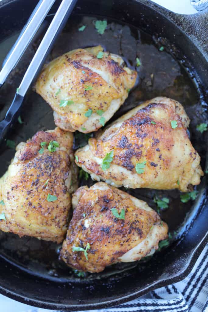 stove top chicken thighs in a cast iron skillet