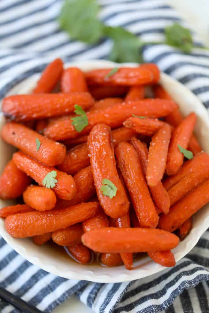 baby carrots in air fryer after cooking in a white bowl