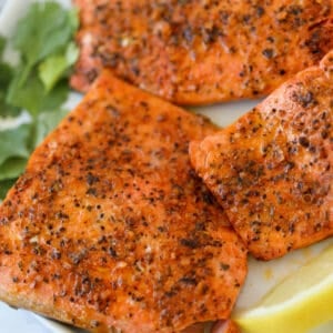 the frozen salmon in air fryer close up on a white plate