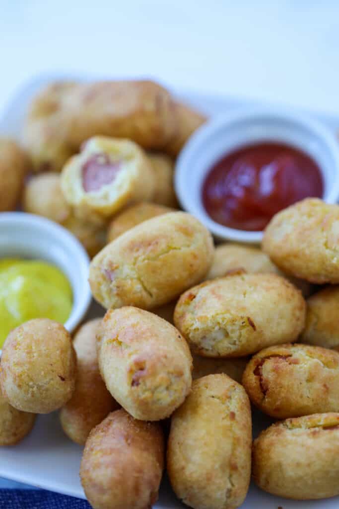 air fryer mini corn dogs on a white plate with mustard