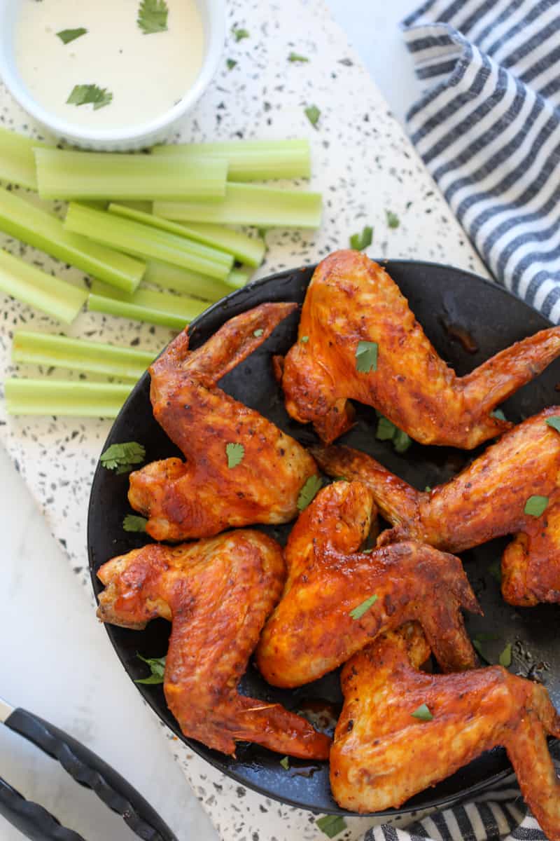 air fryer whole chicken wings with buffalo sauce after cooking
