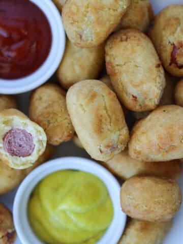 mini corn dogs air fryer close-up with a bite out of a frozen corn dog