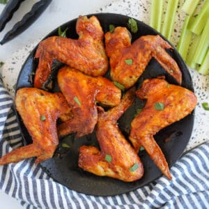 whole chicken wings in air fryer on a black plate ready to serve