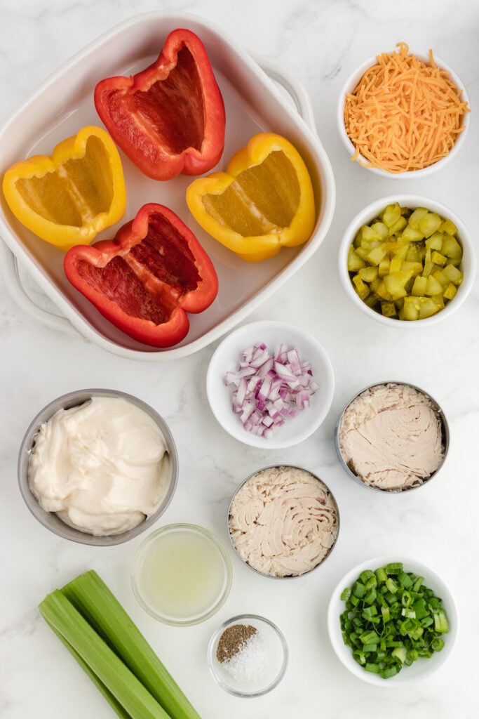 ingredients for the tuna stuffed bell peppers on a marble countertop