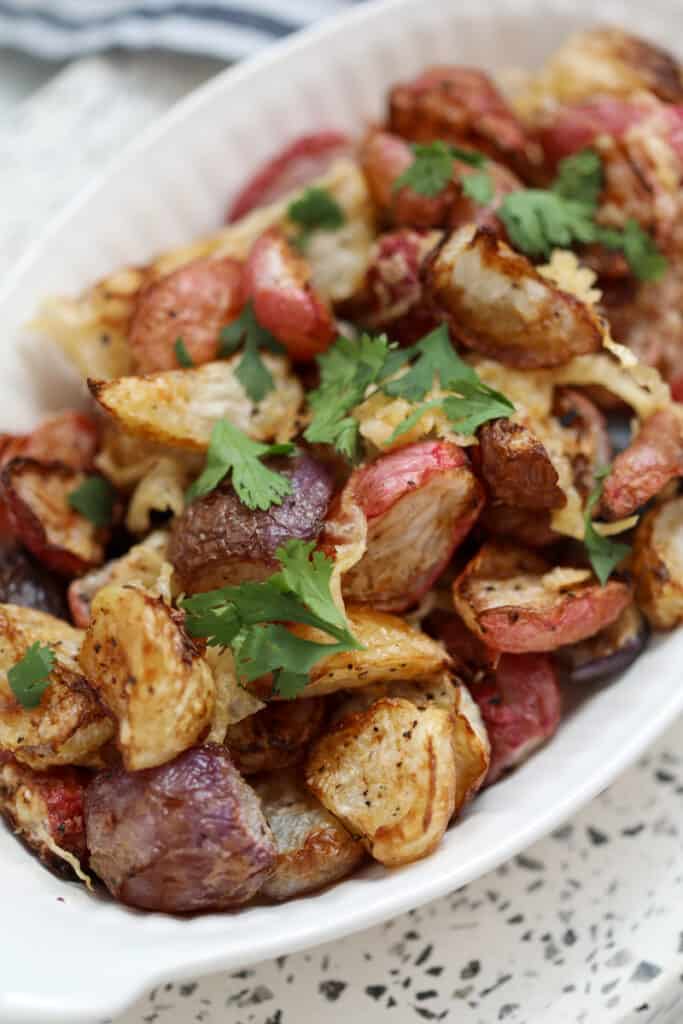 air fried radishes after roasting in a white serving dish