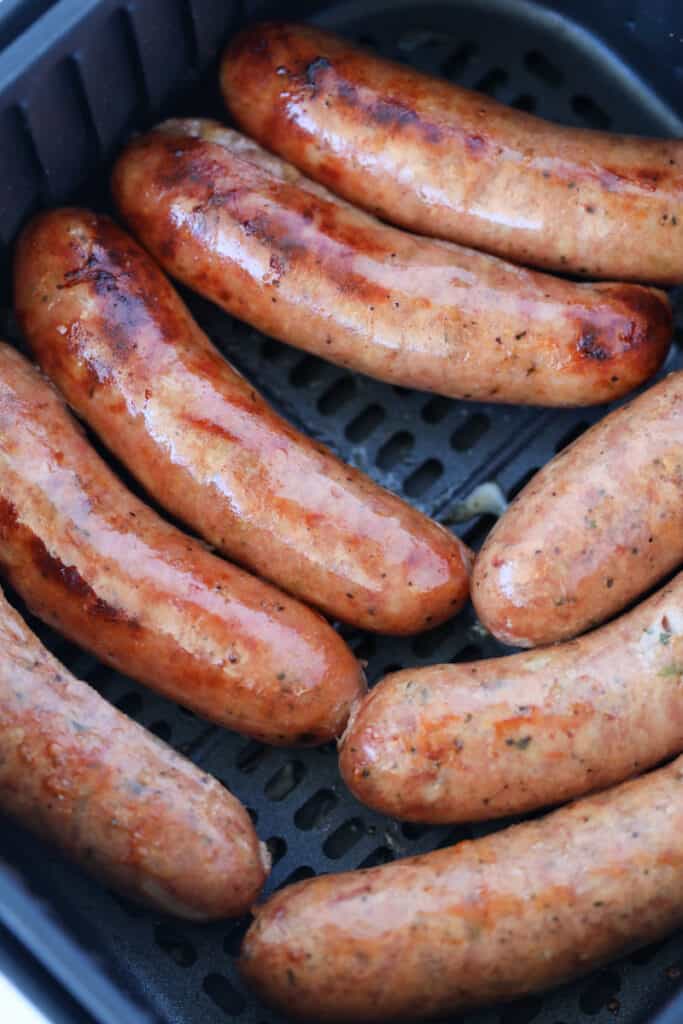 air fryer chicken sausage cooking in the basket