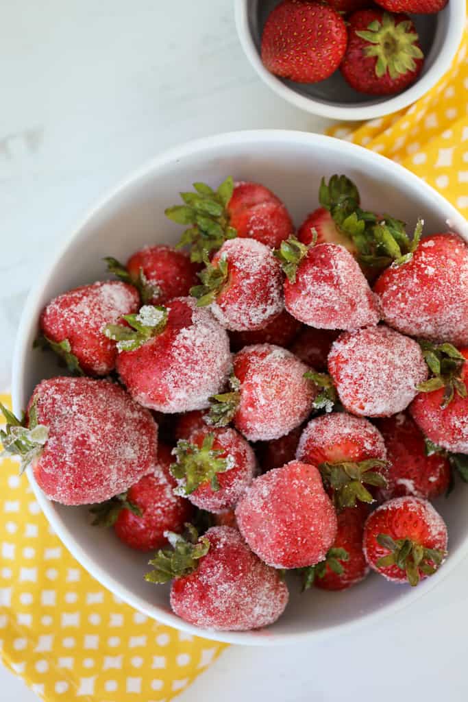 alcohol infused strawberries in a white bowl after dipping