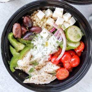 greek salad meal prep bowls combined in meal prep containers for lunches