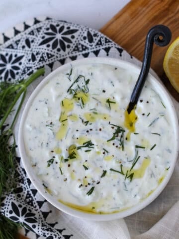 low fat tzatziki sauce using fat free Greek yogurt in a bowl drizzled with olive oil