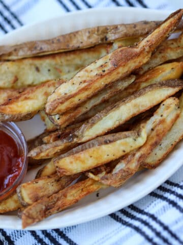 crispy steak fries in air fryer with seasoning and ketchup