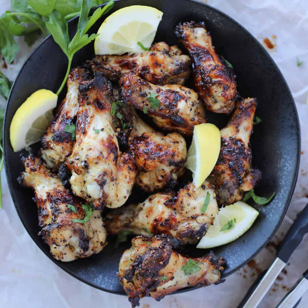 air fryer lemon pepper wings with lemon wedges